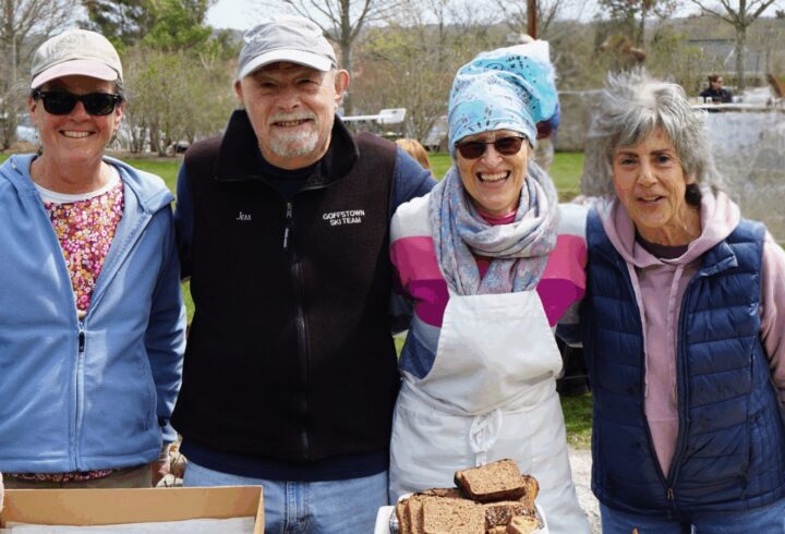 Four volunteers outdoors serving food after the Vineyard Conservation Society Earth Day Beach Cleanup on Martha’s Vineyard