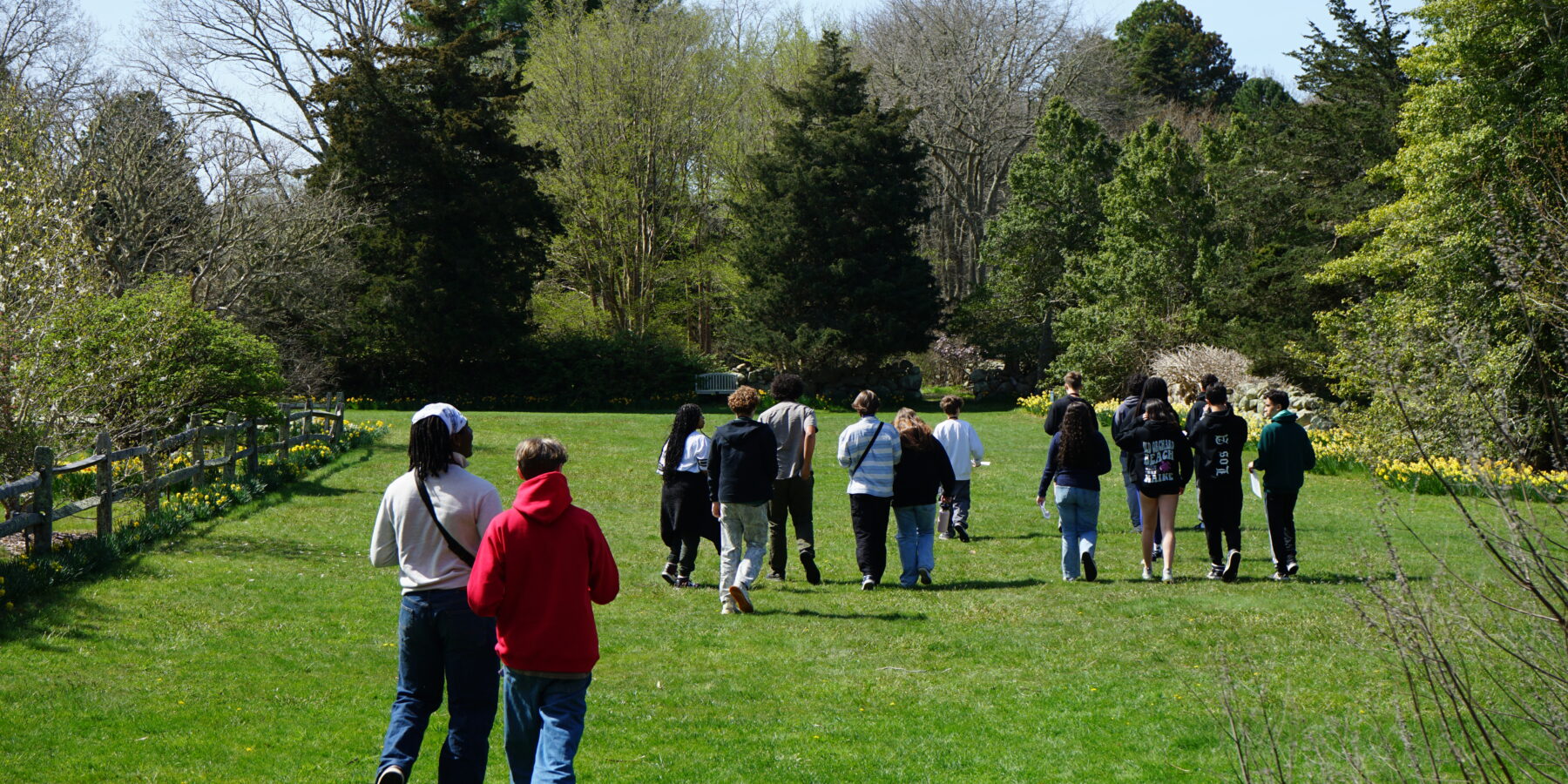 Students walking together through a meadow during a Vineyard Conservation Society youth program