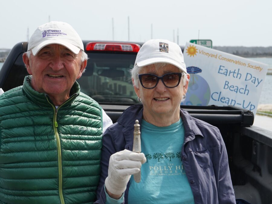 Two volunteers posing with litter collected during the Vineyard Conservation Society Earth Day Beach Cleanup on Martha’s Vineyard